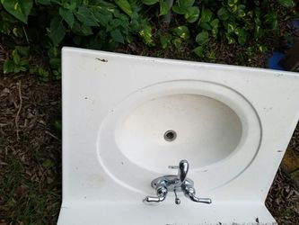 Ceramic sink with Moen faucet that carries a lifetime guarantee.