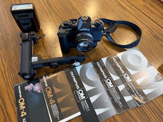 Olympus OM4 film camera setup like new in a collector’s condition.
