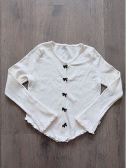 Off-White Bow Button Knit Top w/ Curved Hem & Flared Lettuce Sleeves