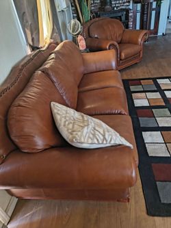 Leather and heavy wood.. couch and char .. nice heavy .. studs