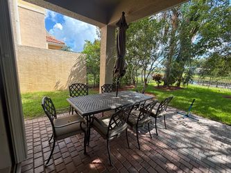 Patio table, chairs, and umbrella