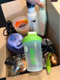 Box full of mostly cups and flasks; Starbucks bottle; blender bottle; some random kitchen items