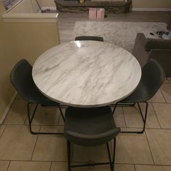 Ashley's Furniture Round Marble Style Kitchen Table With Gray Chairs