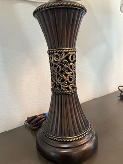 Mariana Table Lamp set from Signature Design by Ashley, featuring a ribbed bronze-finish base with intricate filigree details