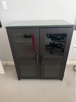 IKEA cabinet with glass doors and protective top