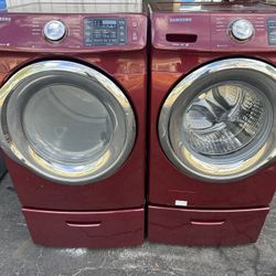 red washing machine and dryer with pedestals, front loading