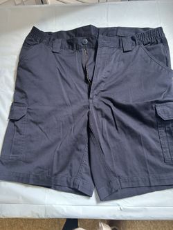 Navy blue cargo shorts with adjustable waistband and multiple pockets. Size: 36" 