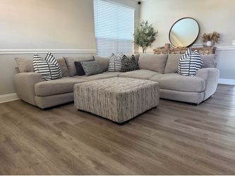 Light gray sectional and ottoman set