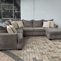 Gray Sectional Sofa from Rooms To Go. Perfect condition.7 decorative pillows included. I can deliver for an additional cost. 