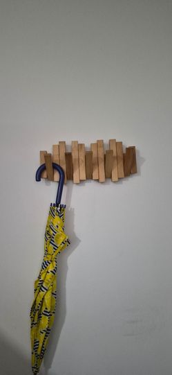Wooden wall coat rack with "piano" design.