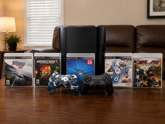 PlayStation 3 with two controllers and 5 games