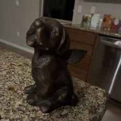 Bronze sculpture of a dog with wings