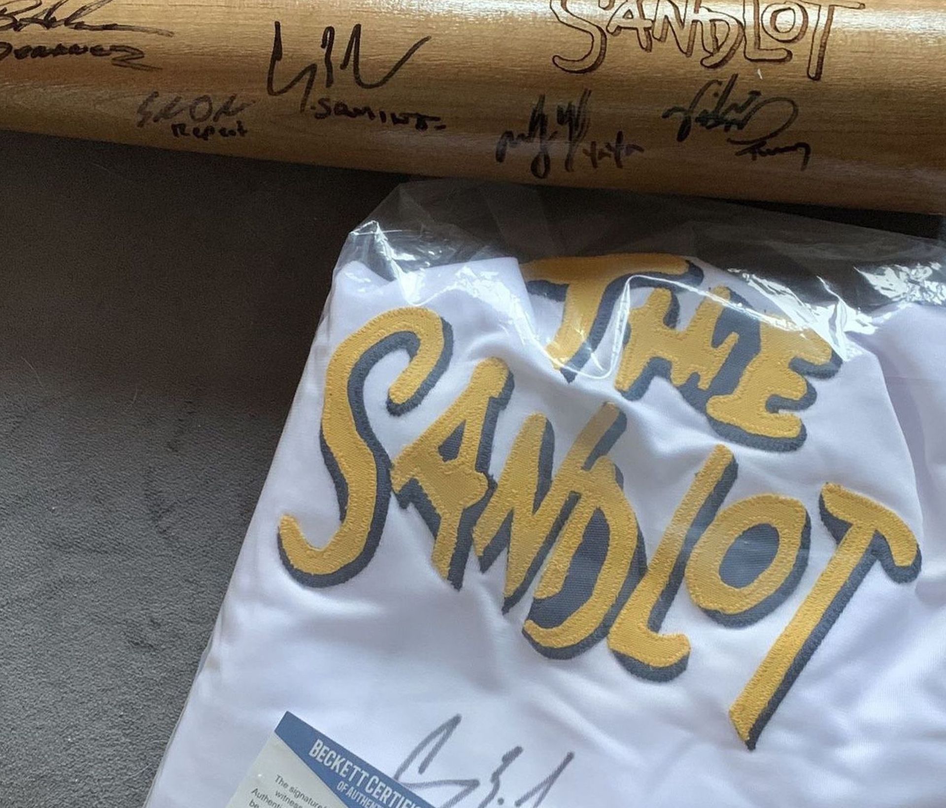 Sandlot jersey and baseball bat each signed by 6
