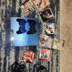 PS3 Blue with two controllers and 8 games