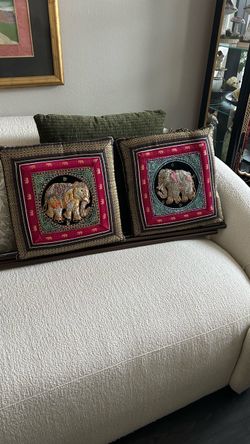 Set of two decorative cushions with elephant design. Purchased while in Thailand. 15-1/2” to 16”.