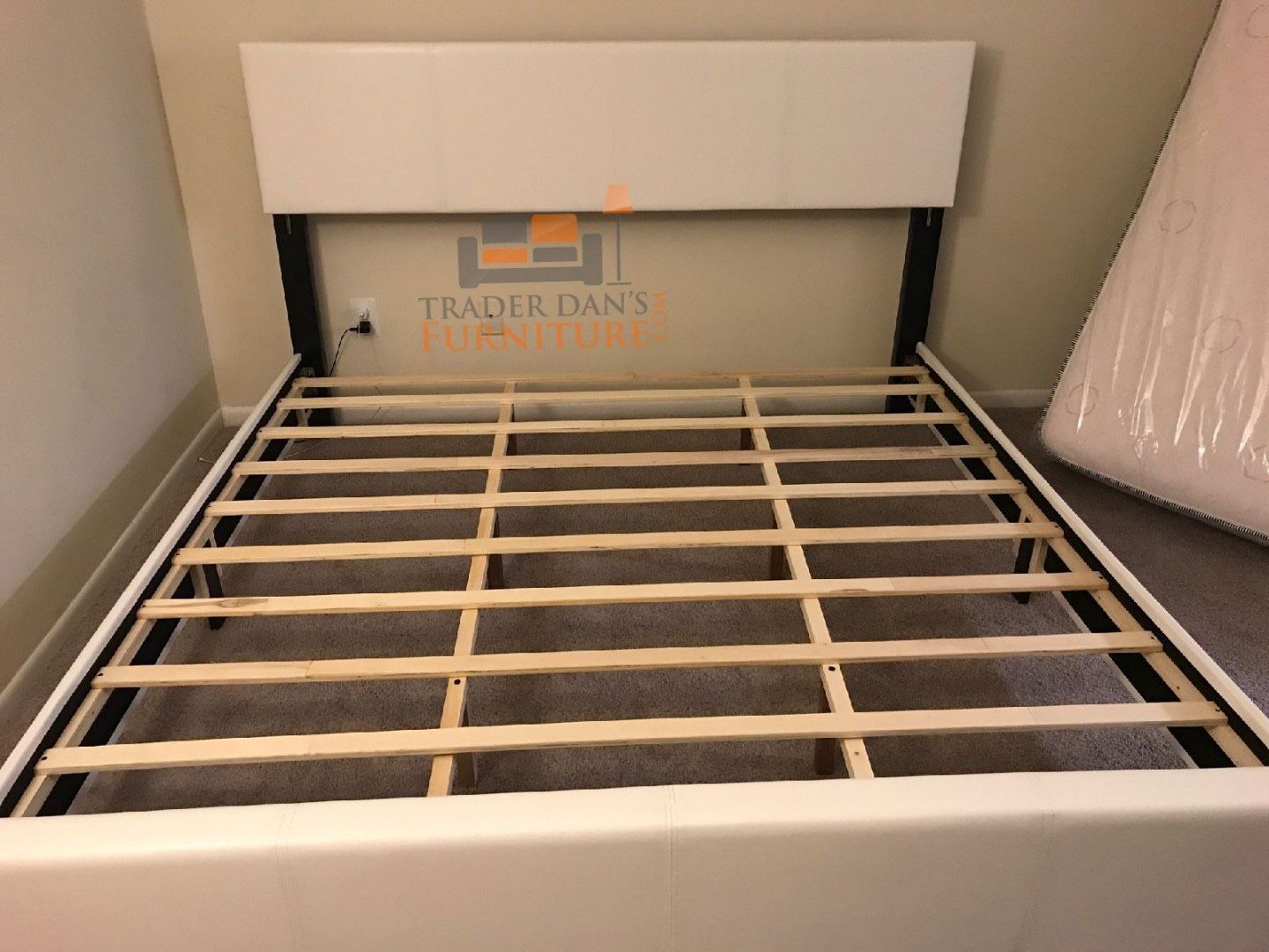 Brand new king size white faux leather platform bed frame.