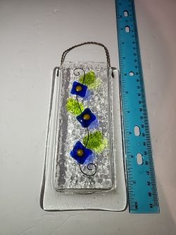 Doug Latta's fused glass hanging pocket vase with a blue flower and green leaf design