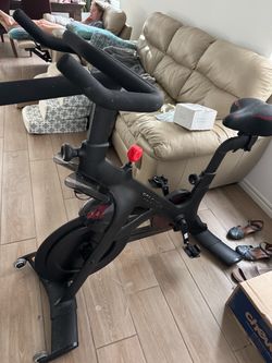 Peloton Original Bike with a notable red resistance knob.This indoor exercise bike is known for its magnetic resistance https://offerup.com/redirect/?