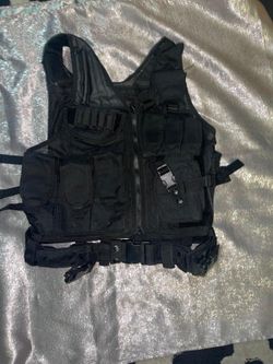 black tactical vest. It is designed for tactical and outdoor use, often seen in activities like airsoft, paintball, hunting, or training.  These vests