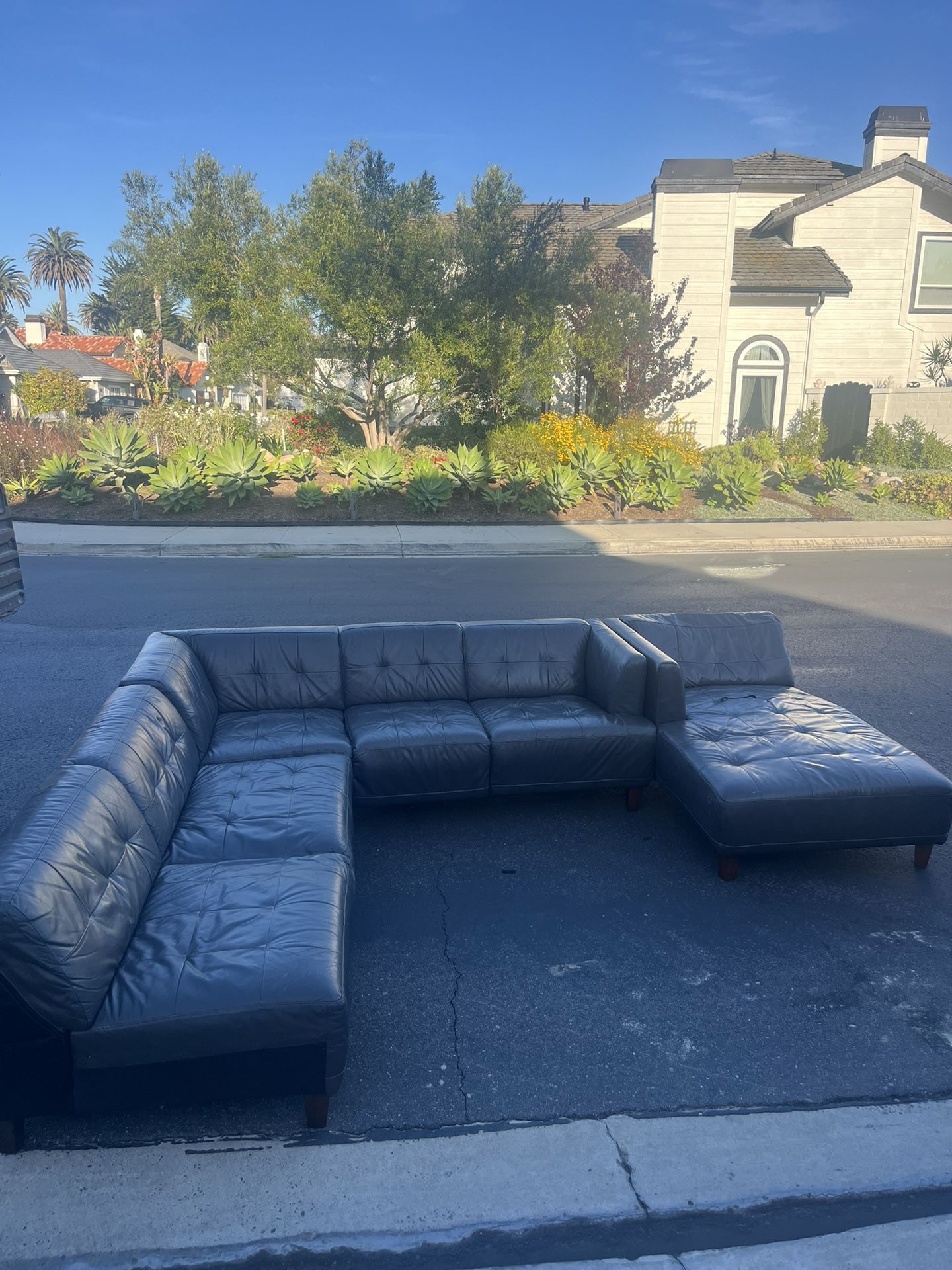 Large grey leather sectional couch