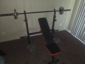 Weight Bench with Barbell and Weight Plates