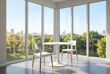 Mid-century modern white round dining table with pair of dining chairs