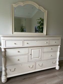 Large French provincial off-white dresser with matching mirror.