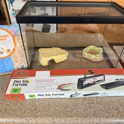 Terrarium with water bowl, hiding fearute, and light