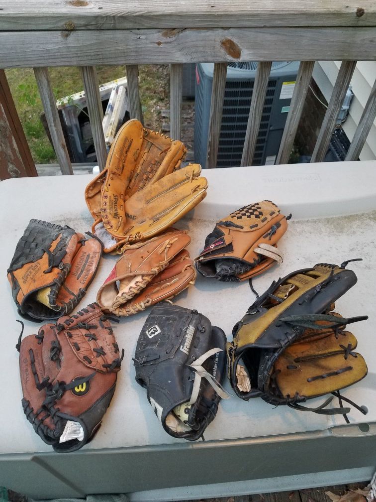 Set of Little league baseball gloves.