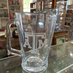 8x9 TEXAS A & M glass pitcher. 25.00.  Johanna at Antiques and More. Located at 316b Main Street Buda. Antiques vintage retro furniture collectibles m