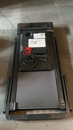 Walking pad treadmill with detachable desk that includes a cupholder and mobile/tablet holder.