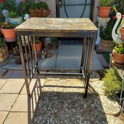 TABLE. NOT STONE OR MARBLE, JUST HAS THAT LOOK