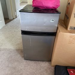 — this is an Igloo compact refrigerator/freezer, likely the 3.2 cu. ft. two-door model. It has a separate freezer on top and refrigerator below. Simil
