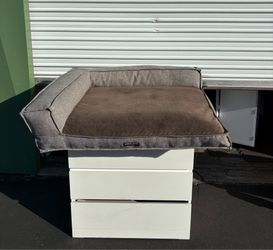 39”x44” Kirkland Signature Bolster Pet Bed features a gray upholstery-grade fabric frame and a brown plush sleeping surface.