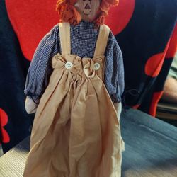 A wooden raggedy Ann