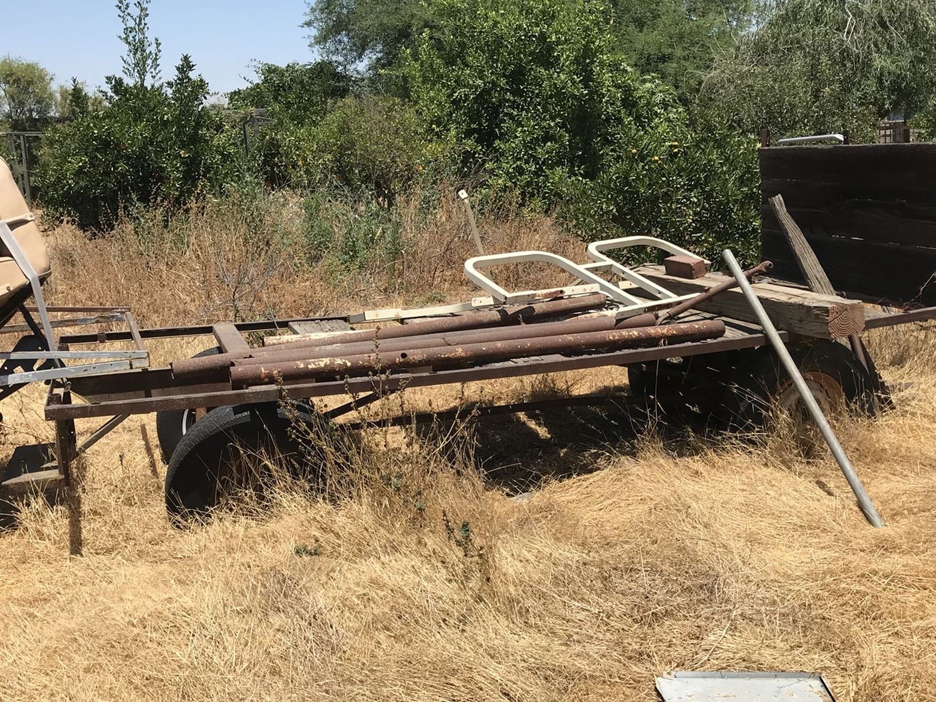 Metal flat bed wagon needs new wood.