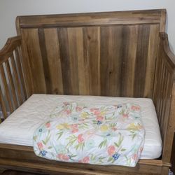 The is a toddler bed but we also have the rail that makes it a crib. Comes with mattress & mattress cover as well as the dresser. No marks!  