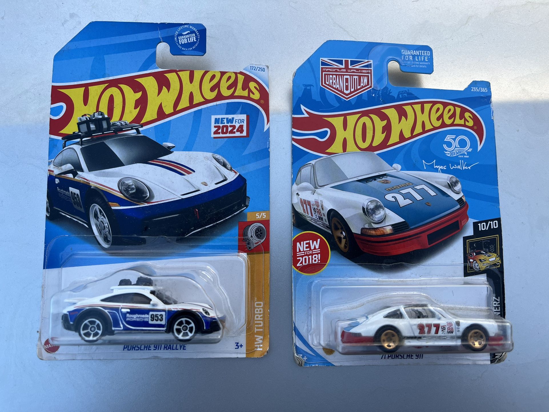 2 Porsche hot wheel cars in the packages