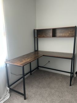 Brown and black corner desk with shelf