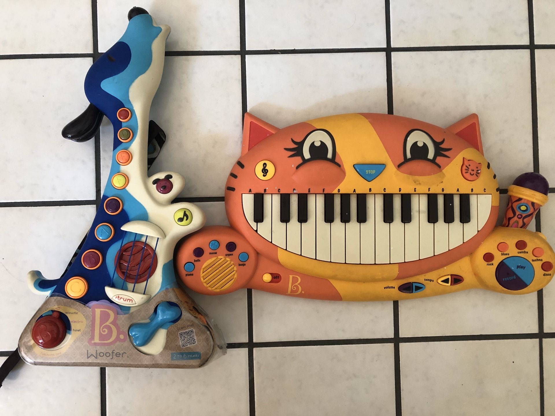 B. Toys Woofer guitar and B. Toys Meowsic keyboard.