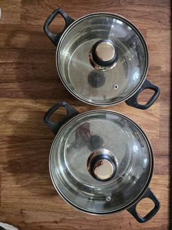 Durable stainless steel pots are Gourmet Chef brand. Set of 2 pots has glass lids and capsulated base for even heating.