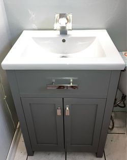 Gray bathroom vanity with sink and faucet
