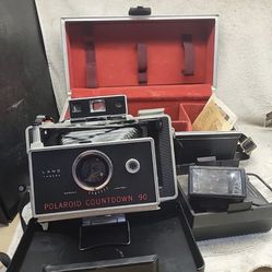 Vintage Polaroid Countdown 90 Automatic Land Camera with accessories.