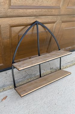 Synovana arched foldable metal and wood wall shelf featuring a black frame and two tiered wooden shelves.