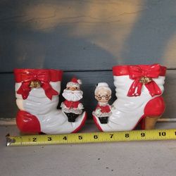 Santa and Mrs Claus Sitting on the Toe of Bow and Bell Trimmed Christmas Boot 