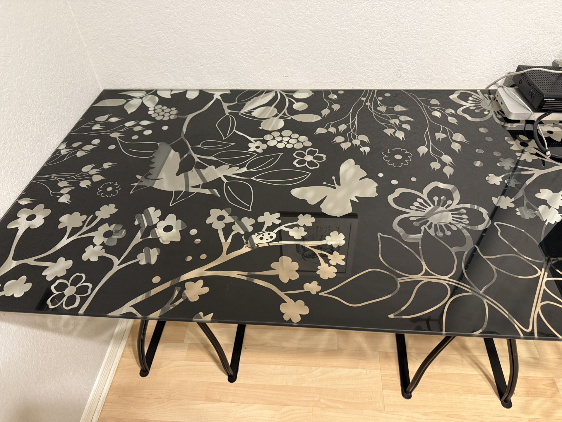 IKEA black and clear glass desk top with two black metal base.