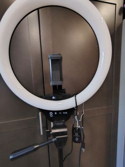 LED ring light with a tripod stand and phone folder.