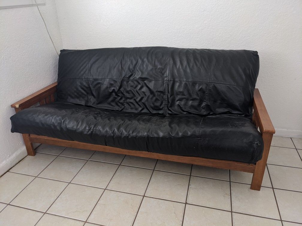 Used wood and fake leather futon