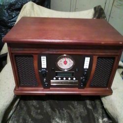 Used Wooden music center w/ recordable CD player.