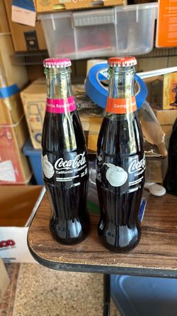 Coca Cola. 2 filled bottles.